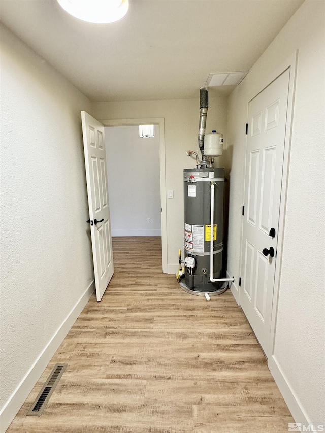 utility room with strapped water heater