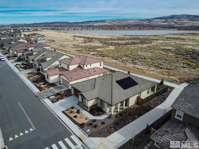 drone / aerial view with a water and mountain view