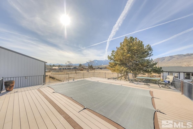 deck with a mountain view and a patio area