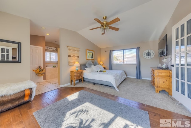 bedroom featuring multiple windows, lofted ceiling, ceiling fan, and wood-type flooring