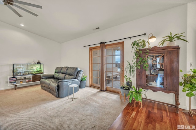 living area featuring carpet floors and ceiling fan