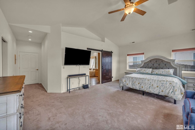 carpeted bedroom with ceiling fan, a barn door, and vaulted ceiling