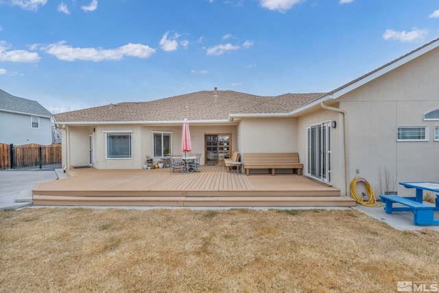 back of house with a yard and a wooden deck