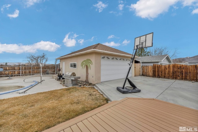 exterior space featuring a patio, a garage, and a yard