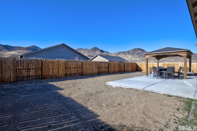 view of yard featuring a mountain view, a gazebo, and a patio area