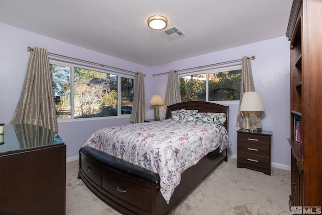 carpeted bedroom with multiple windows