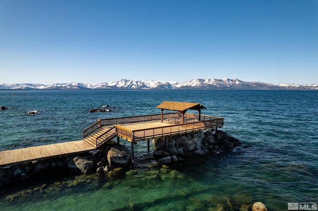 view of dock featuring a water and mountain view