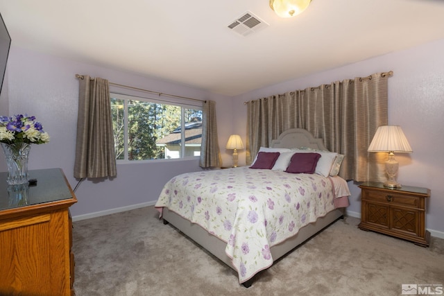 bedroom featuring light carpet