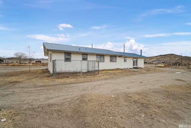 rear view of house featuring a mountain view