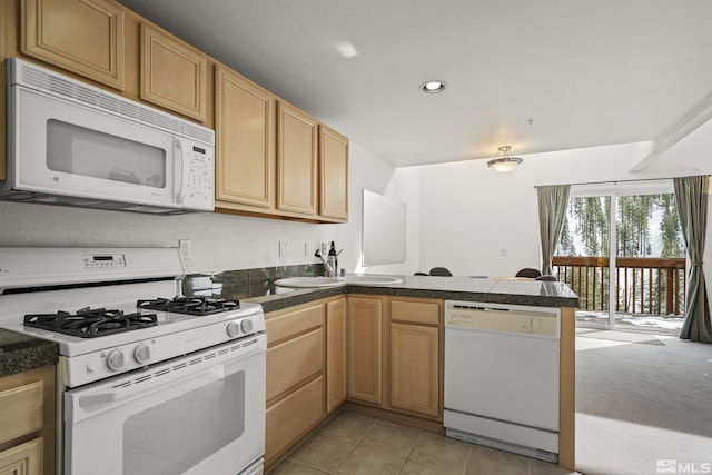 kitchen featuring sink, kitchen peninsula, white appliances, and light tile patterned flooring