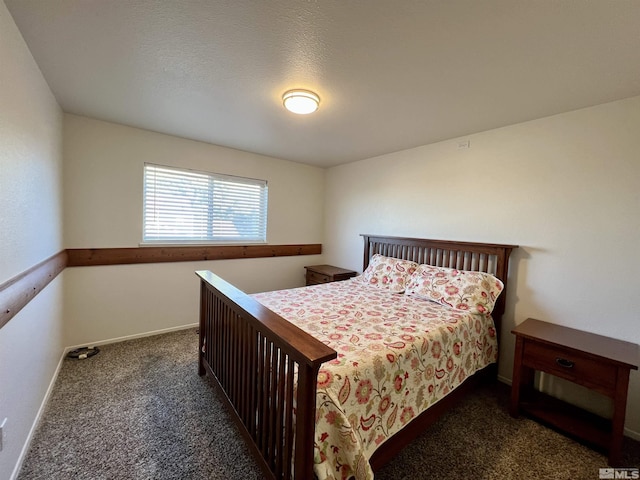 bedroom featuring dark colored carpet