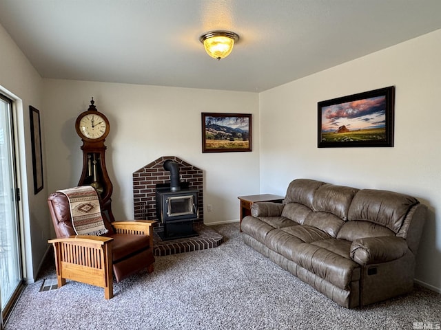 living room with a wood stove and carpet