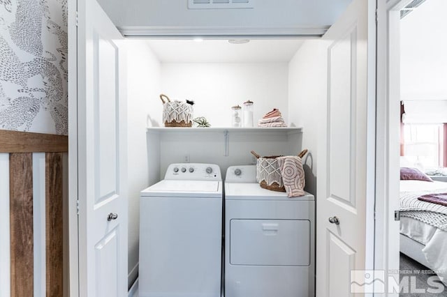 clothes washing area featuring washing machine and dryer