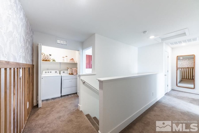 corridor featuring washer and clothes dryer and light colored carpet