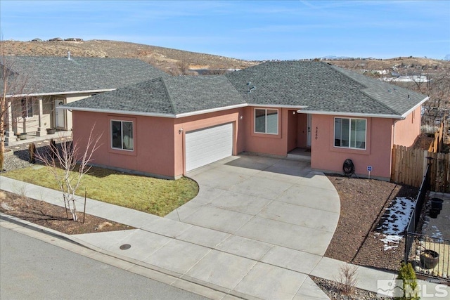 ranch-style house featuring a garage and a mountain view