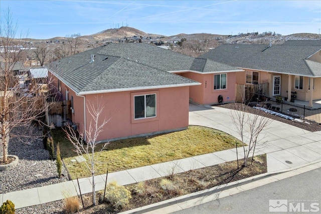 view of home's exterior featuring a mountain view and a yard