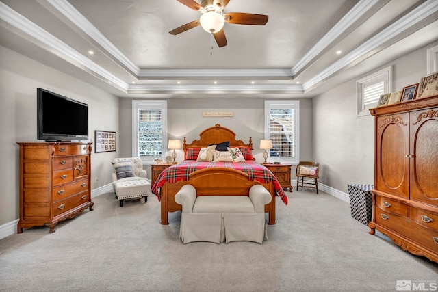 bedroom featuring ornamental molding, light colored carpet, ceiling fan, and a raised ceiling