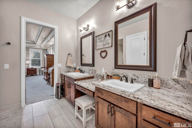 bathroom with a tray ceiling and vanity