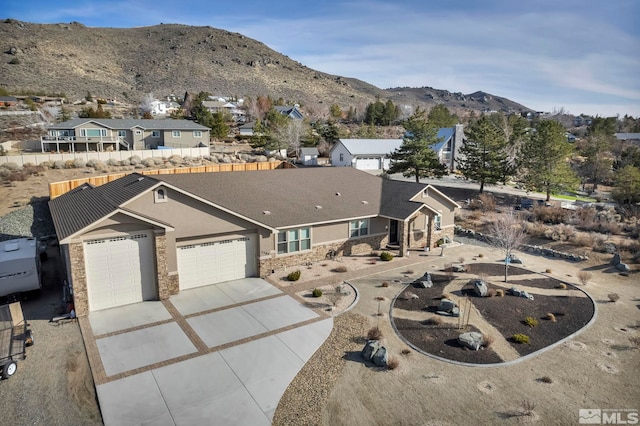 view of front of home with a garage and a mountain view