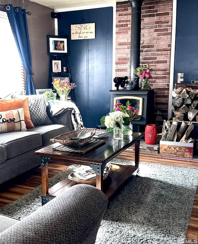 living room featuring a wood stove and hardwood / wood-style flooring