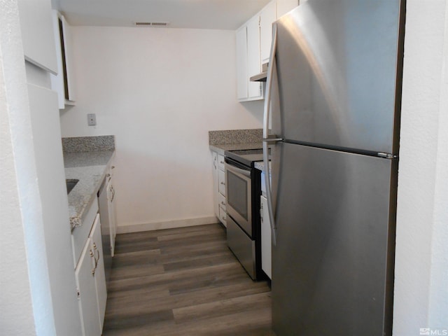 kitchen with white cabinets, light stone countertops, stainless steel appliances, and dark hardwood / wood-style floors