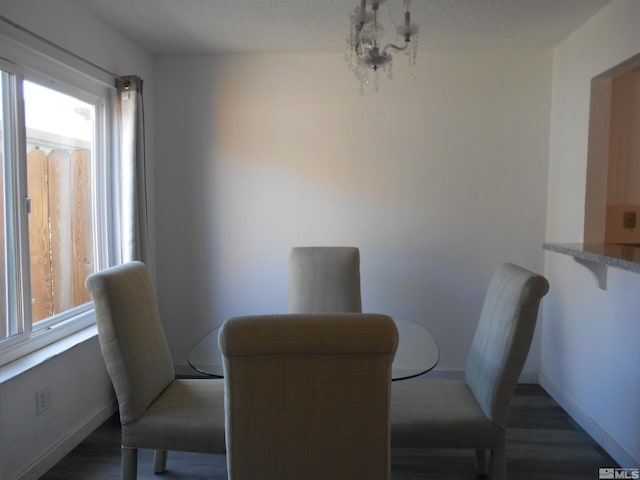 dining space with a chandelier, dark hardwood / wood-style floors, and plenty of natural light