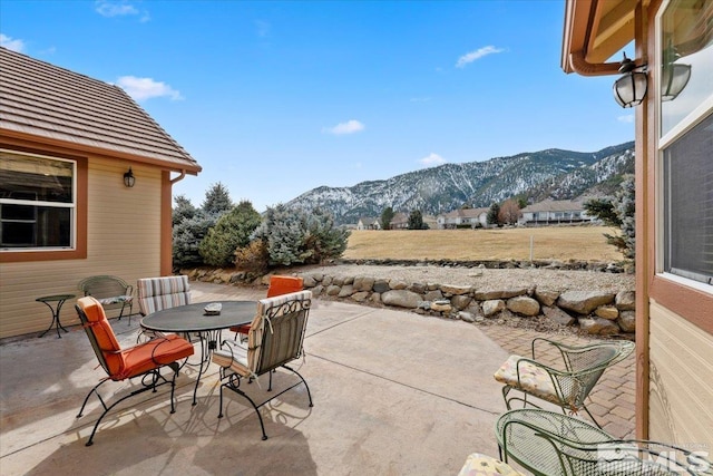 view of patio / terrace featuring outdoor dining space and a mountain view