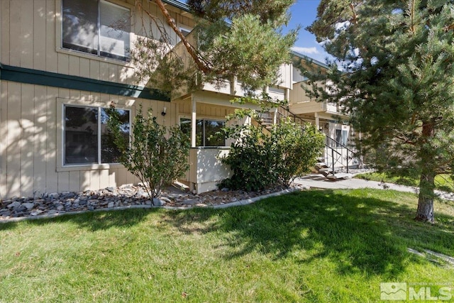 view of side of home featuring a lawn