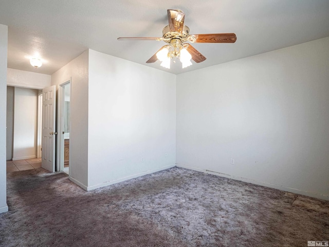 spare room with light colored carpet and ceiling fan