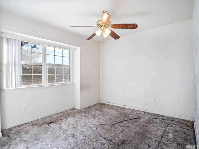 unfurnished room featuring baseboards, ceiling fan, and light carpet