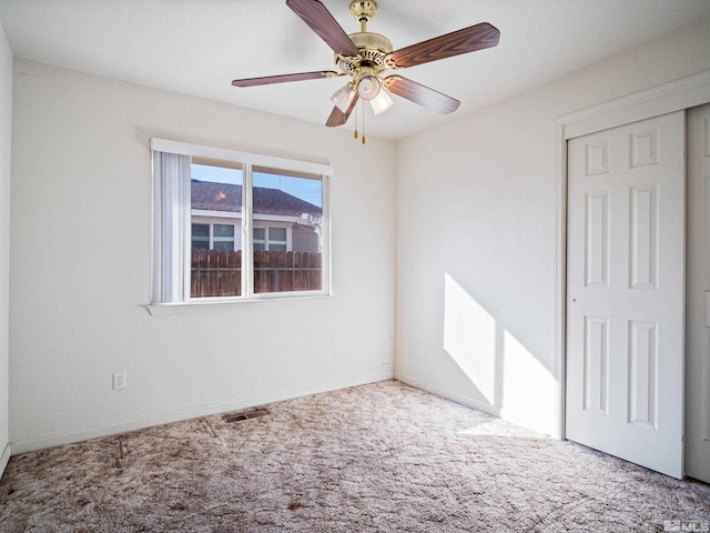 unfurnished room with baseboards, visible vents, ceiling fan, and light carpet