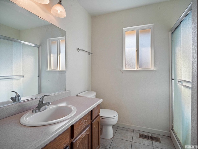 bathroom featuring baseboards, visible vents, toilet, vanity, and tile patterned floors