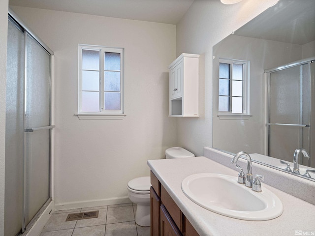 full bathroom featuring vanity, visible vents, a shower with door, toilet, and tile patterned floors