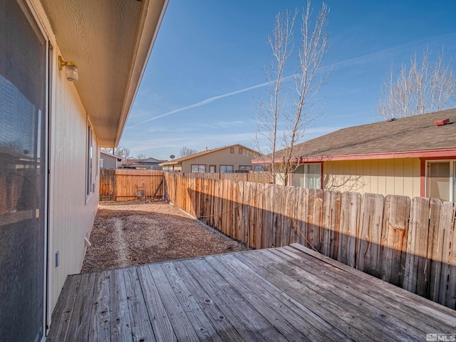 wooden terrace featuring a fenced backyard