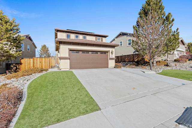 view of front of home with a front yard, concrete driveway, fence, and stucco siding