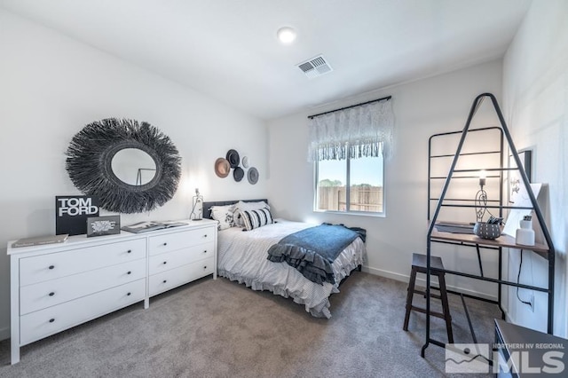 bedroom with carpet floors, visible vents, and baseboards