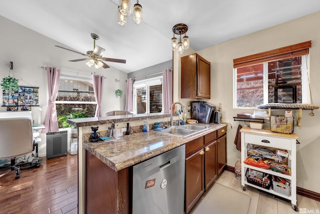 kitchen featuring brown cabinets, dishwasher, a peninsula, and a sink