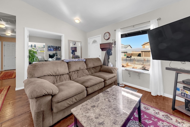 living area featuring lofted ceiling, baseboards, visible vents, and dark wood finished floors