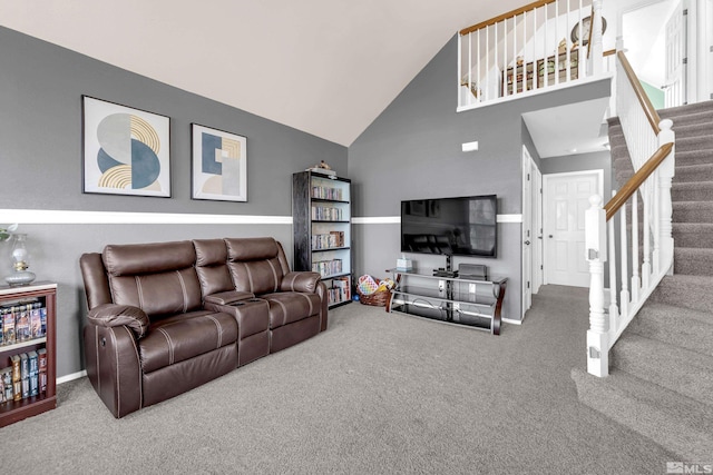 living area featuring carpet floors, baseboards, stairs, and high vaulted ceiling