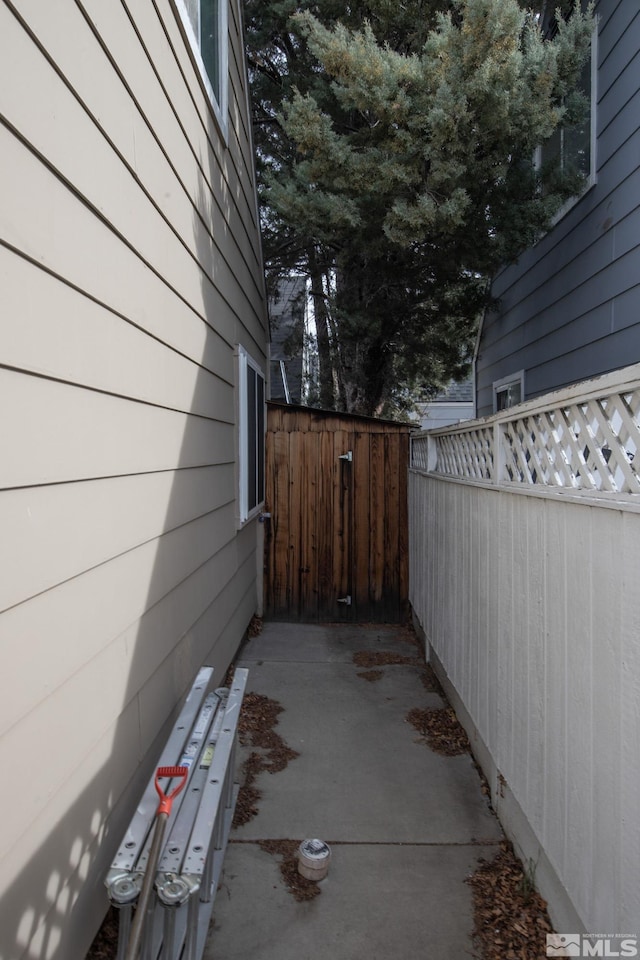 view of side of property with a patio area and fence