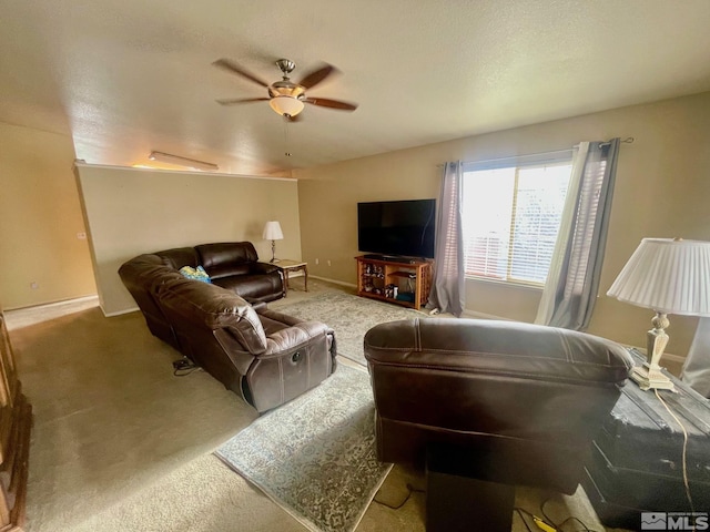 living room featuring carpet, ceiling fan, and baseboards