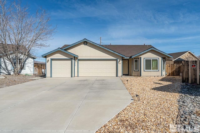 ranch-style house with driveway, an attached garage, and fence