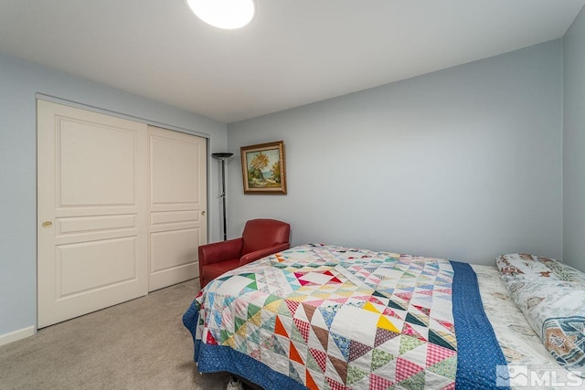 bedroom with light carpet and a closet