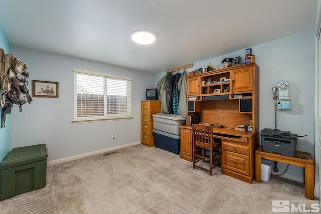 home office featuring visible vents, baseboards, and light colored carpet