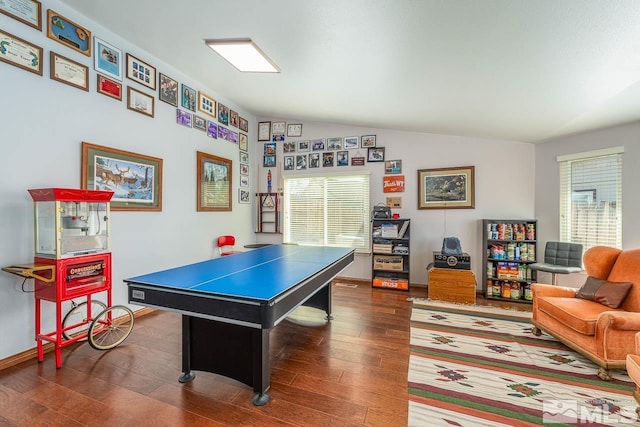 recreation room featuring lofted ceiling, dark wood finished floors, and baseboards