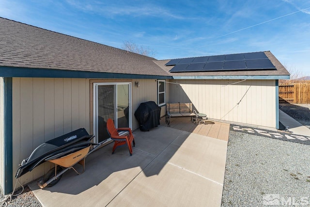 view of patio featuring area for grilling and fence