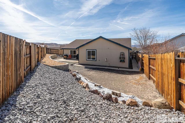 rear view of property with a patio area and a fenced backyard