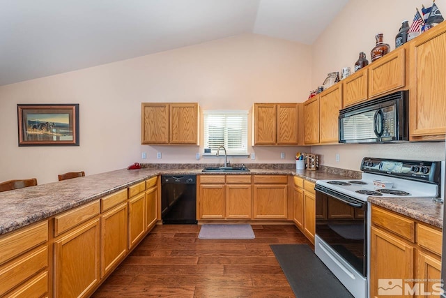 kitchen featuring dark wood-style floors, lofted ceiling, dark countertops, a sink, and black appliances