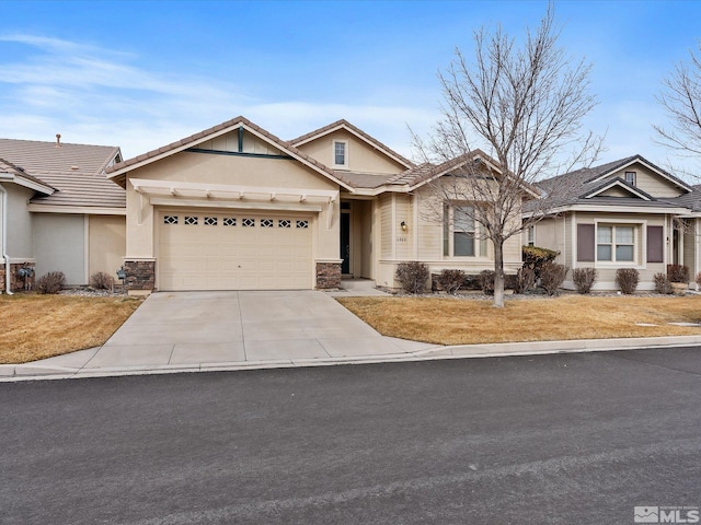 view of front of house featuring driveway, an attached garage, and stucco siding