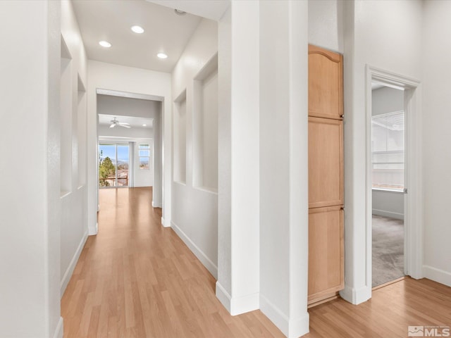 corridor with baseboards, recessed lighting, and light wood-style floors